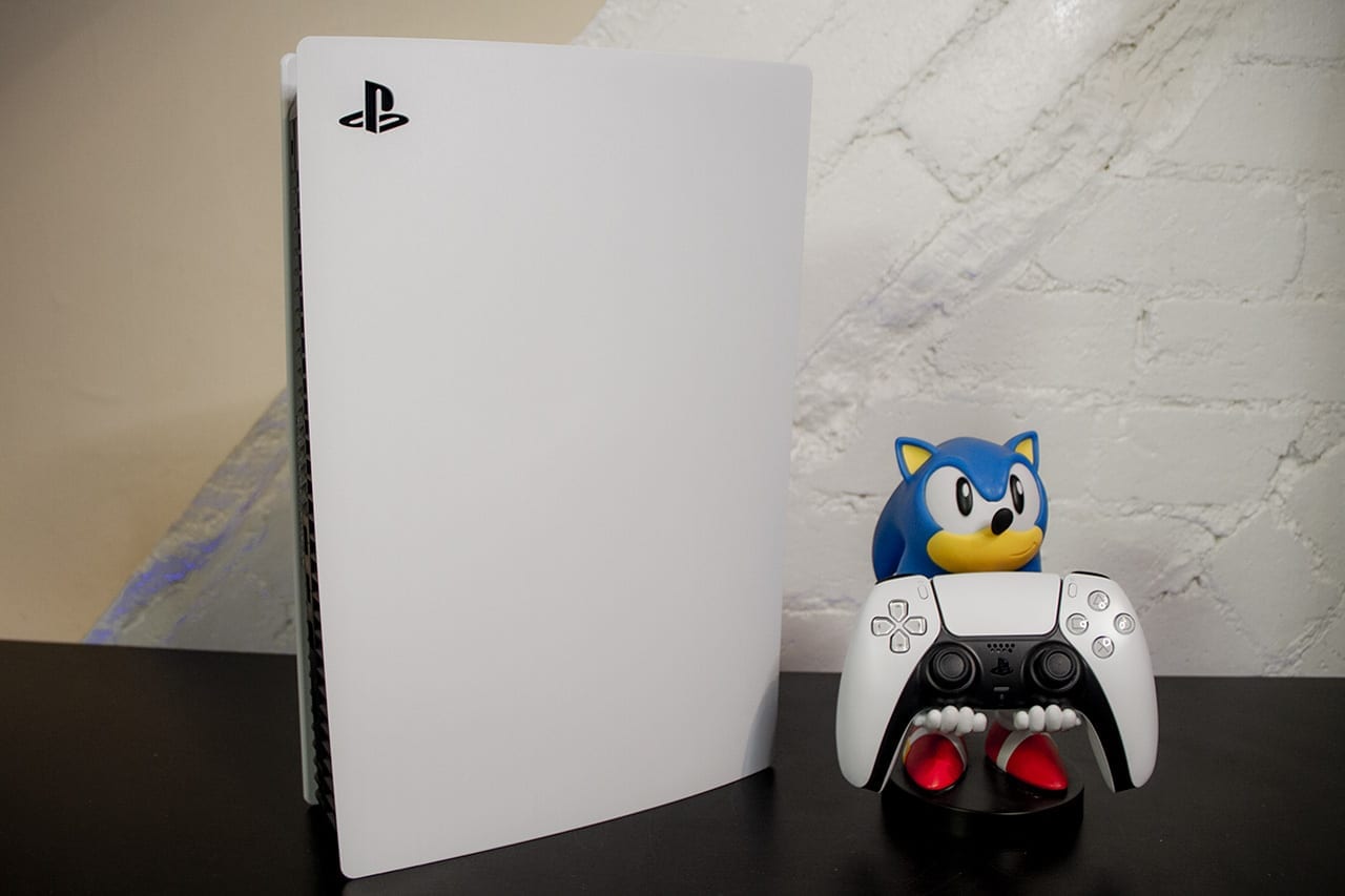 A photo of the PlayStation 5 with a Sonic the Hedgehog figure holding the DualSense controller.