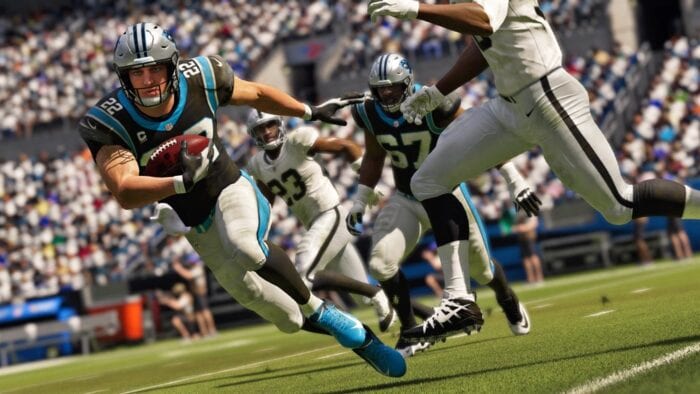 Madden 21 screenshot showing a player running with the ball close to their chest