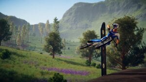 A bike is flying through the air in the video game Descenders with lush green trees in the background